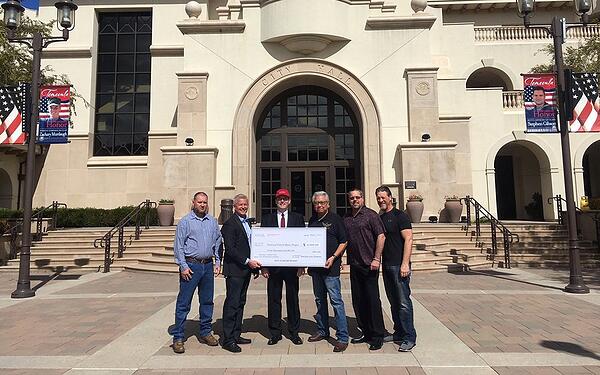 A check is presented to help veterans' mental health through music.